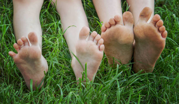 istock Children's legs on green grass. Selective focus. 1728150633