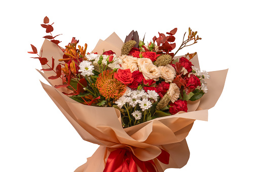 Autumn bouquet of yellow and orange flowers. Beautiful floral arrangement with fall orange and red flowers and berries, closeup. Cozy Interior fall decor with Autumn composition plants at home.