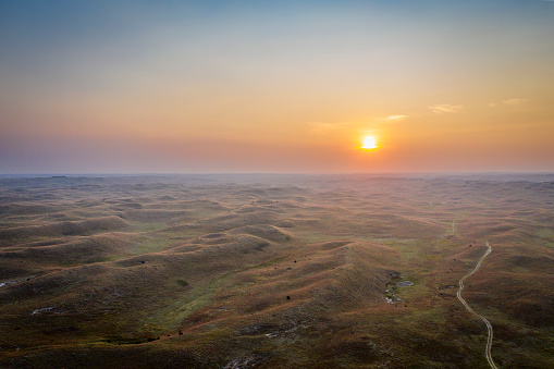 hazy sunrise over Nebraska Sandhills at Nebraska National Forest, aerial view of fall scenery affected by wildfire smoke from Colorado and Wyoming