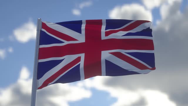 Union Jack flag of the United Kingdom proudly fluttering in the wind