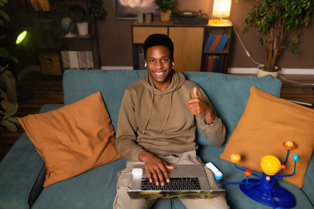 istock Happy delighted african american dark skinned black man responding to a message comment from followers friends family on social media, indicating his agreement or appreciation for the content 1728164560