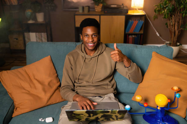 istock Happy handsome african american guy student expressing his satisfaction with his work or progress on a project giving a positive review of product or service on a website or social media platform 1728165346
