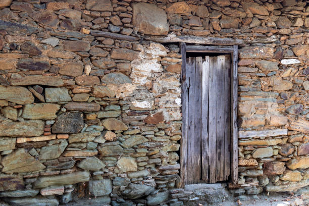istock Stone masonry structure, old type wooden door detail. 1728168747