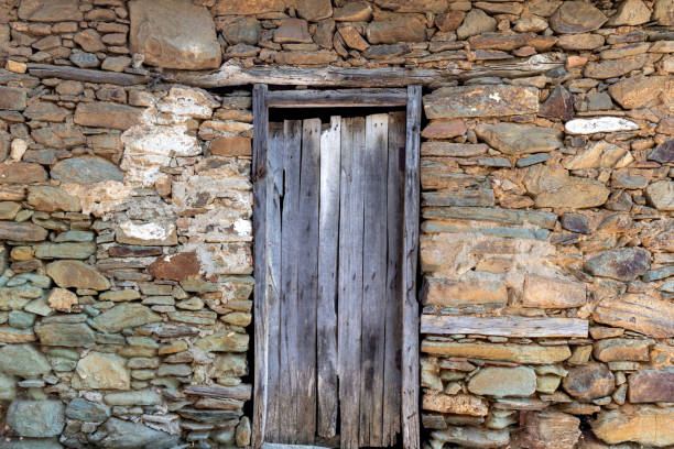 istock Stone masonry structure, old type wooden door detail. 1728170955