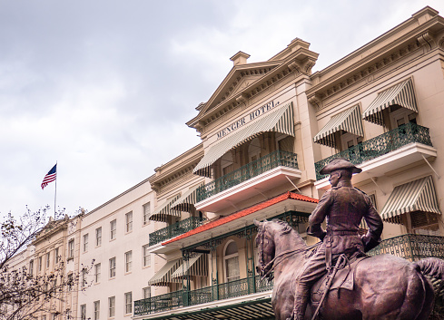 Menger Hotel, San Antonio, Texas - USA: Equestrian Teddy Roosevelt statue in front of the historic Menger Hotel, Alamo Plaza, San Antonio, Texas, with American flag