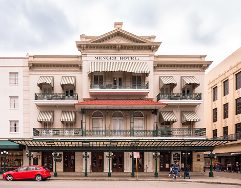Menger Hotel, San Antonio, Texas - USA: Facade of historic Menger Hotel, Alamo Plaza, San Antonio, Texas, with small group of people walking
