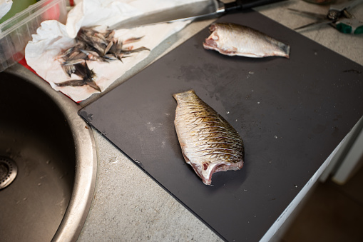 Kipper a Whole Smoked and Cured Herring or Salted Fish on White Paper