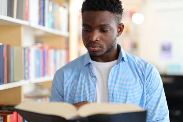 istock A serious young student studying diligently in a university library, surrounded by books and knowledge resources. 1728206984