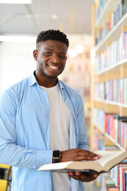 istock A smart young adult in a modern library, studying with determination, surrounded by books and knowledge. 1728207009