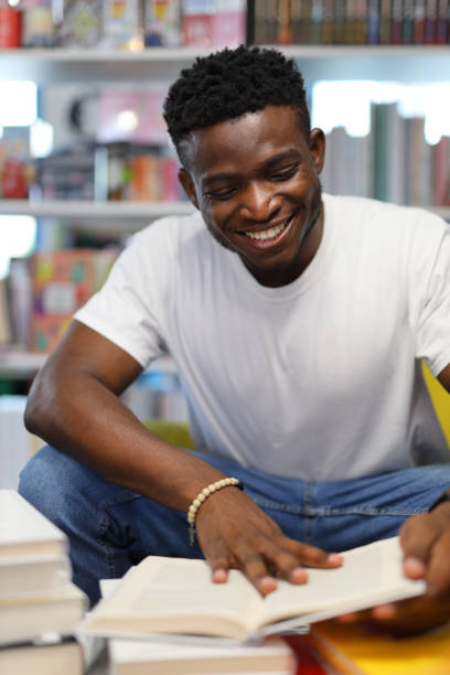 istock A focused young student in a university library, engrossed in academic pursuits, surrounded by books and knowledge. 1728208109