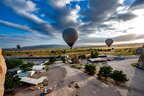 Hot Air balloons flying tour over Mountains landscape spring sunrice Cappadocia, Goreme Open Air Museum National Park, Turkey nature background.