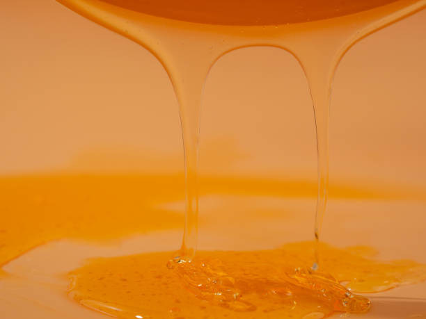 istock Liquid shower gel flows gracefully across a bright orange background. 1728215364