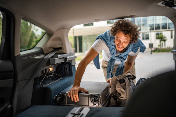 istock Man is packing luggage in a car trunk 1728216468
