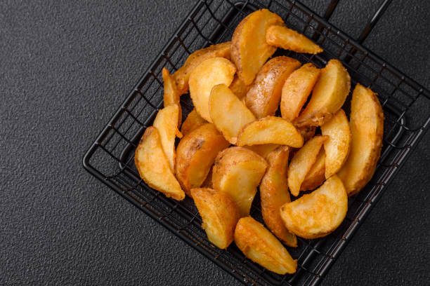 istock Delicious crispy fried potato wedges with salt, spices and herbs 1728218101