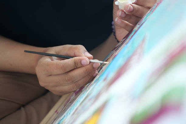 istock women hand holding brush with paint 1728227378