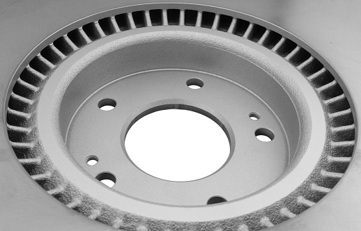 Car brake disc isolated on white background. Auto spare parts. Perforated brake disc rotor isolated on white. Braking ventilated discs. Quality spare parts for car service or maintenance