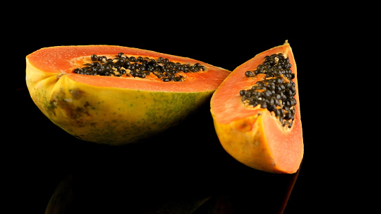 Papaya with red flesh. Papaya can be used as food, cooking aid and in traditional medicine. 