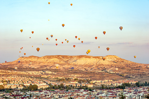 Hot air balloons flying over Kızılçukur, view from Ürgüp town