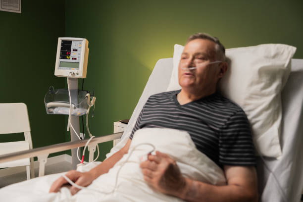 Senior patient with oxygen tube and finger oxygen monitor, shows signs of exhaustion, possibly due to heart condition Senior patient with oxygen tube and finger oxygen monitor, shows signs of exhaustion, possibly due to heart condition. night hospital bed stock pictures, royalty-free photos & images