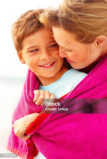 Caring Mother Embracing Her Son While At The Beach Looking At Eachother Stock Photo - Download Image Now