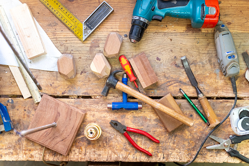 Top view of work tools in a workshop wood table