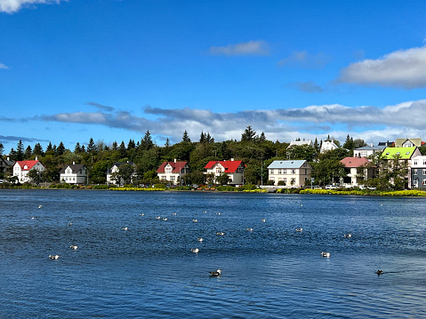 Visitors to the city explore the area around the Reykjavik City Pond, locally known as Tjörnin,