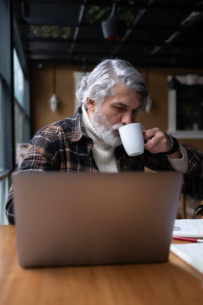 istock Portrait of a businessman on a coffee break using laptop 1728283081