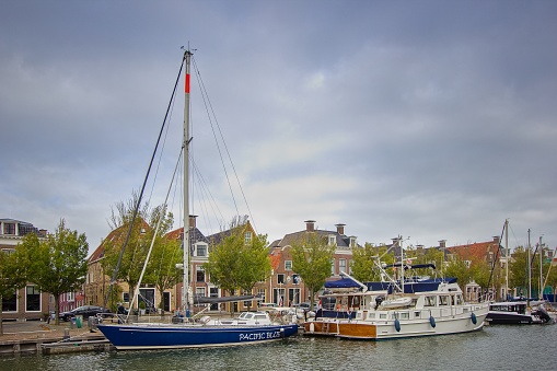 The sailboat moored on a canal in the city of Harlingen, Friesland, the Netherlands
