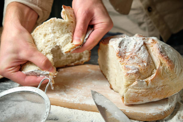 istock man holding slices of freshly cut bread 1728302850