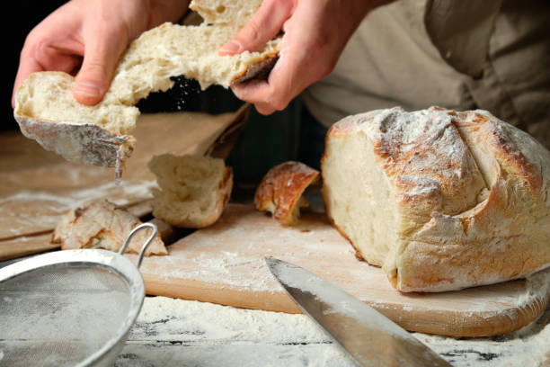 istock man holding slices of freshly cut bread 1728302857
