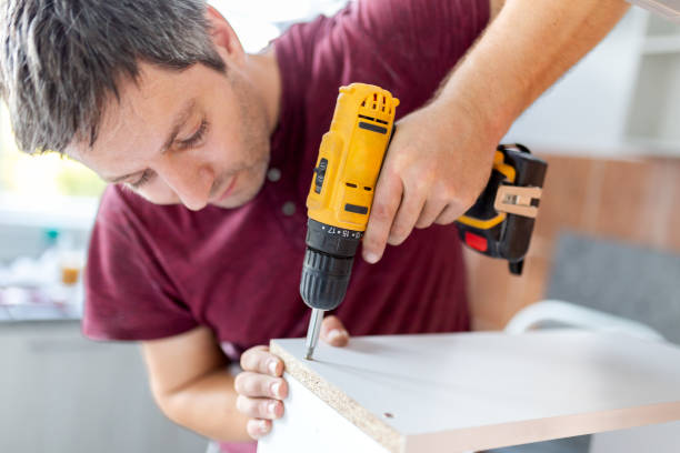 istock Professional carpenter working with electric cordless screwdriver. Kitchen installation concept. 1728304438