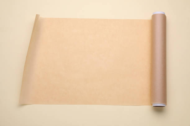 istock Roll of baking paper on beige background, top view 1728309005
