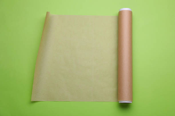 istock Roll of baking paper on light green background, top view 1728309023