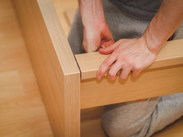 istock A caucasian young man connects with his hands a wooden long board with a headboard 1728335601