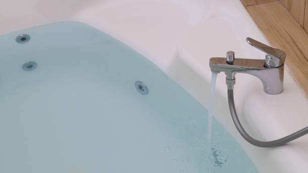 istock Water running into hot tub in bathroom 1728335680