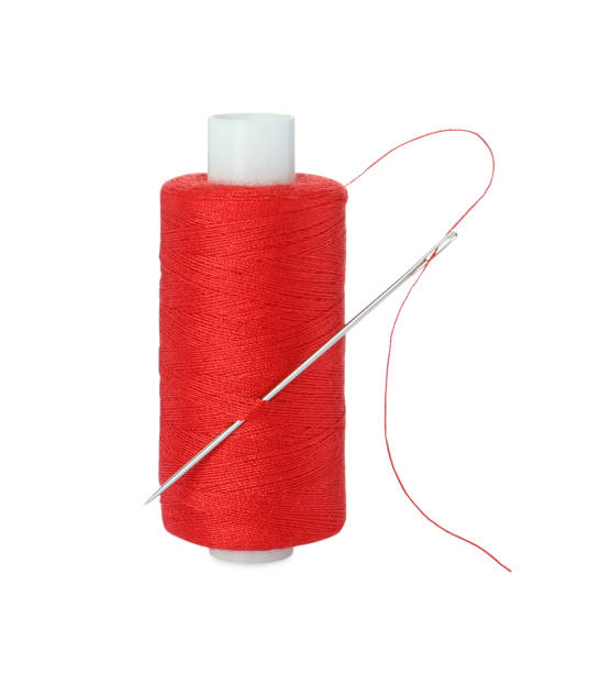istock Spool of red sewing thread with needle isolated on white 1728351169