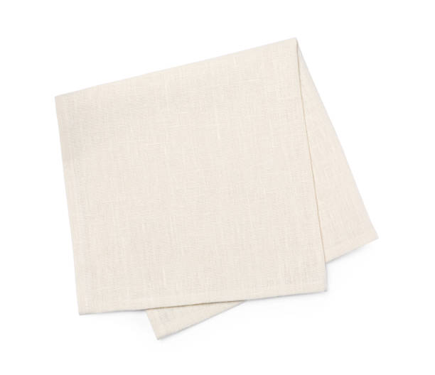 istock Beige fabric napkin on white background, top view 1728353385