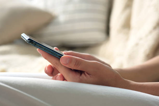 istock Young woman with smartphone on sofa, closeup 1728367698