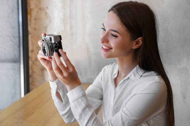 istock Young woman taking picture at cafe. Creative hobby 1728368251