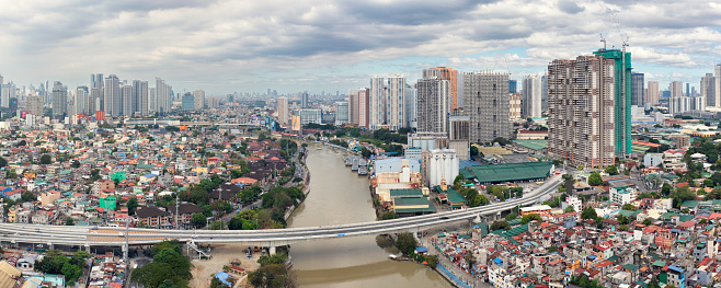 View of the Kalayaan Bridge crossing the Pasig river. In the background are skyscrapers in the Mandaluyong and Makati districts of Metro Manila.