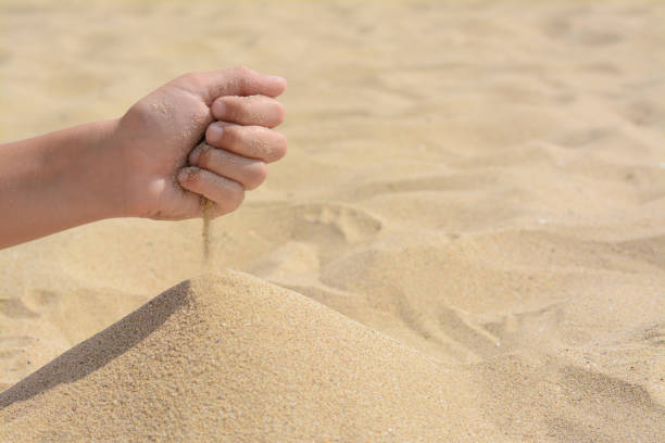 istock Child pouring sand from hand on beach, closeup with space for text. Fleeting time concept 1728402560