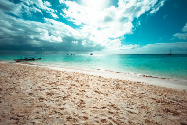 View of Beautiful Tropical Beach and Sea in Sunny Day With Colorful Sky and Dramatic Clouds. Zanzibar, Tanzania. Summer Holiday and Vacation Concept.