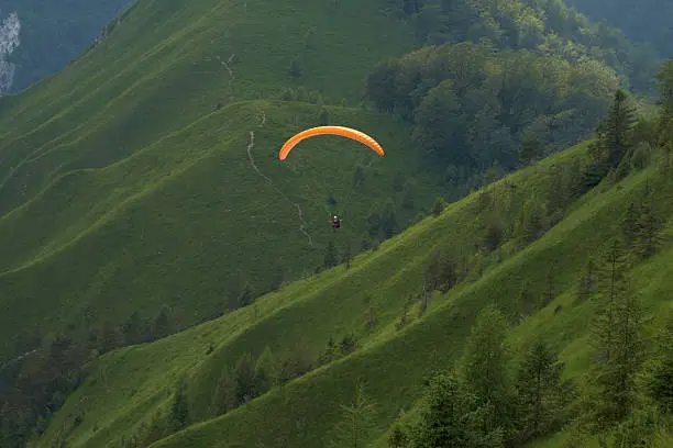 Photo of Paraglider (orange) in flight