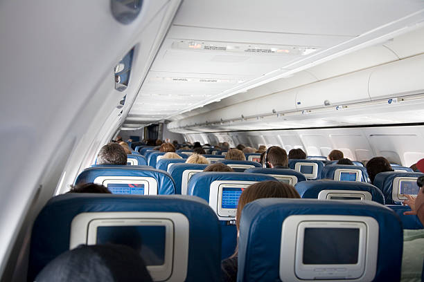 Commercial Airplane Cabin Full of Passengers stock photo