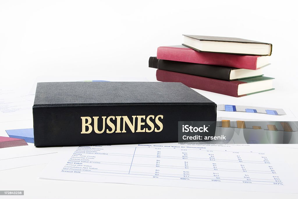 Big book of business Business book on top of statements, graphs, and other books in the background. Banking Stock Photo