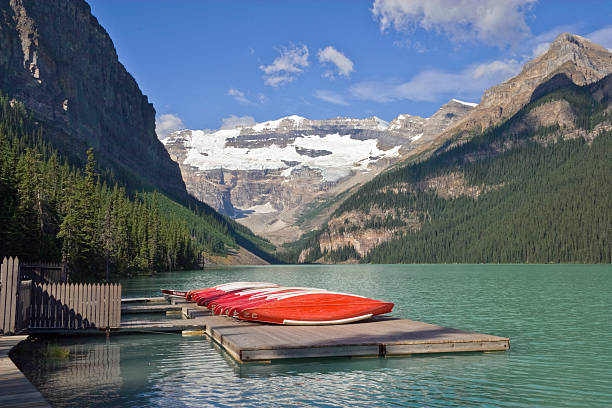 istock Lake Louise with red canoes and blue sky 172843579