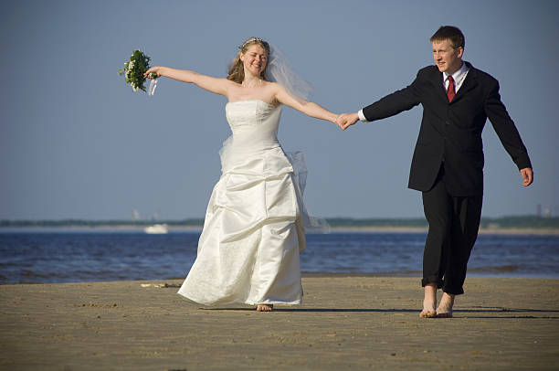 istock Wedding couple walking at the beach 172844148