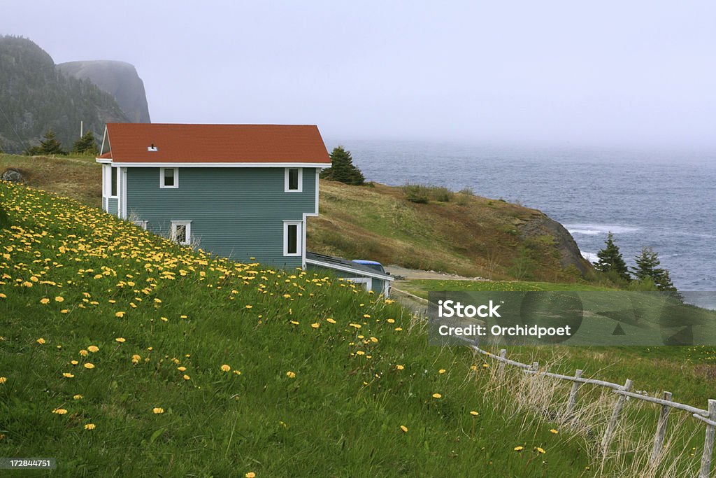 Picturesque Newfoundland Coast Colorful little house at picturesque foggy Atlantic coastline in Newfoundland Atlantic Ocean Stock Photo