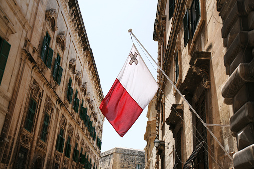 National maltese flag hanging from official building