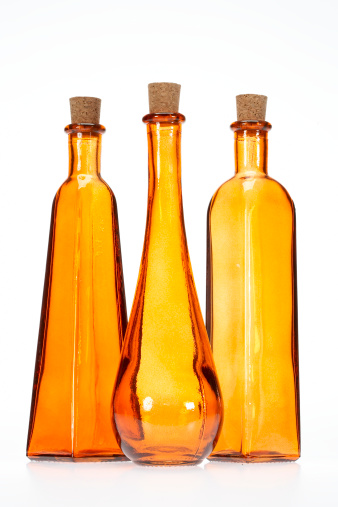 Three orange bottles with different shapes